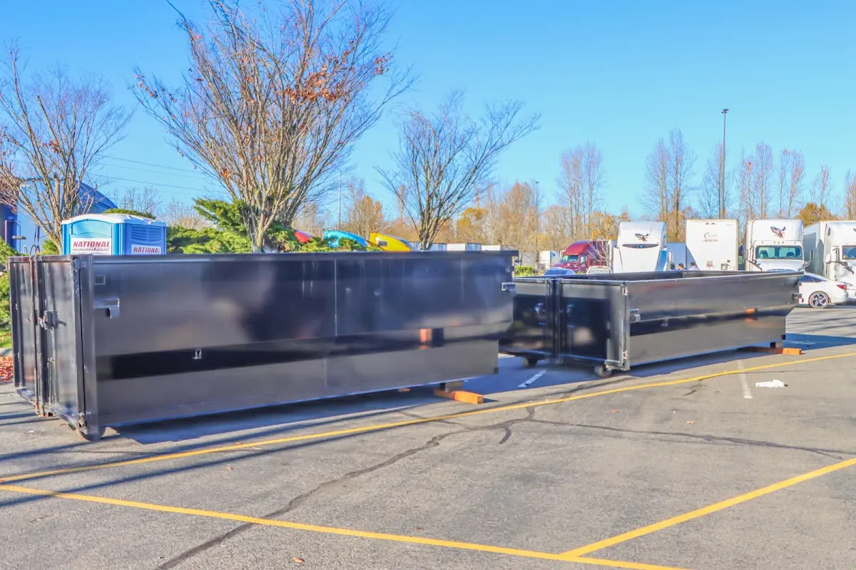 Professional dumpster rental service with roll-off container on residential driveway in Wickliffe